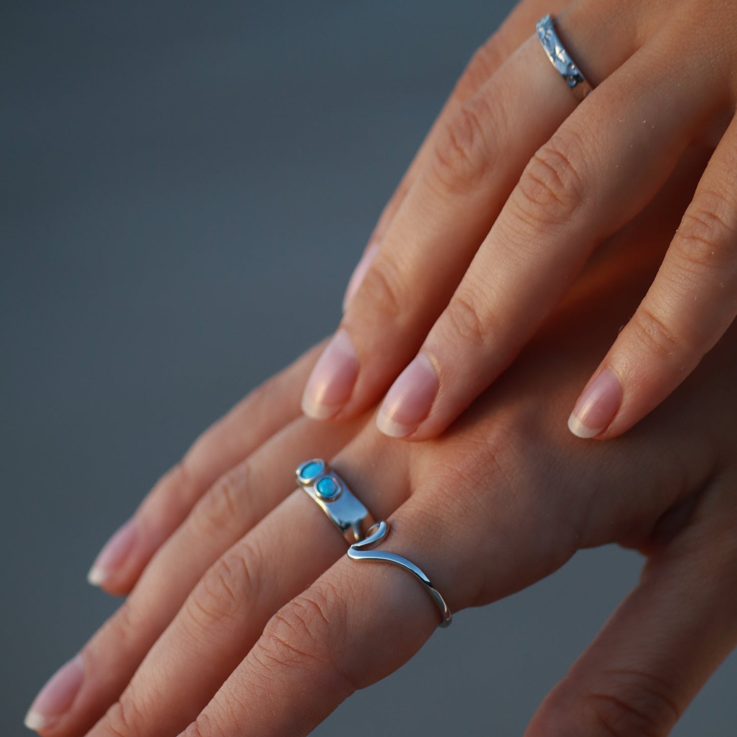 silver opal past present future ring worn on fingers with elegant design and beautiful opals