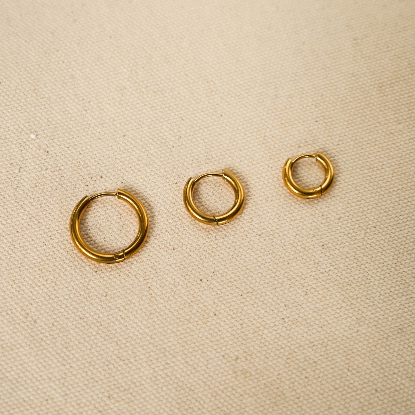 Everyday essential hoop earrings set features three sizes: 8mm, 14mm, and 18mm, in a sleek gold design.