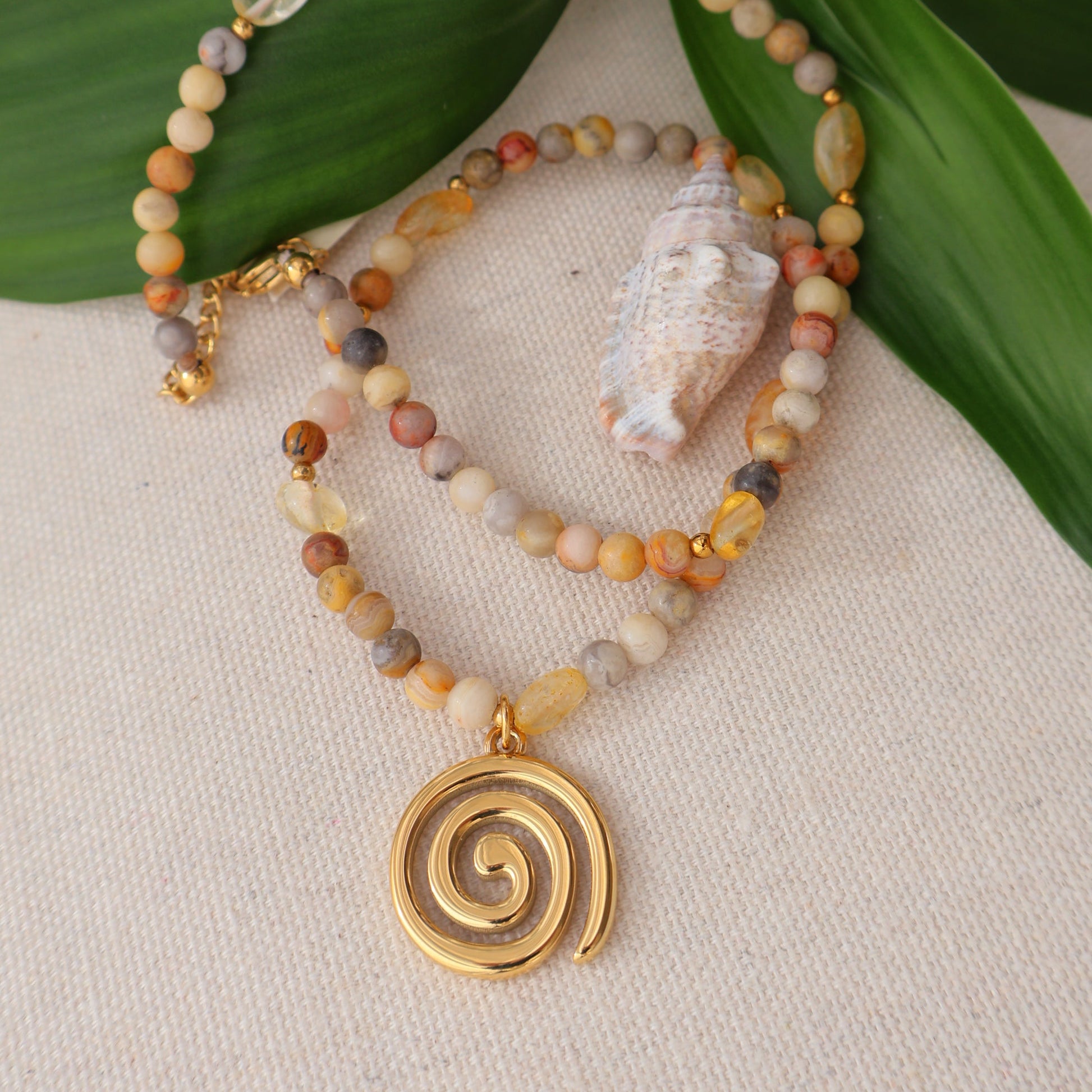 Beaded necklace with gemstone with gold spiral charm