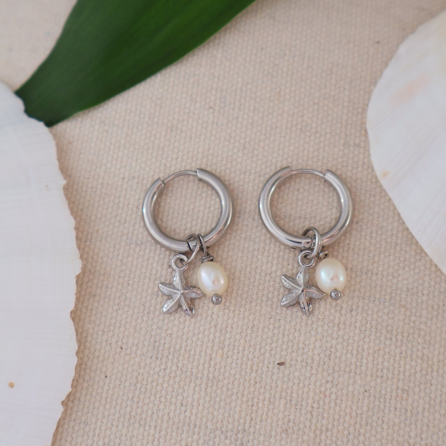 Silver earrings with star and pearl designs