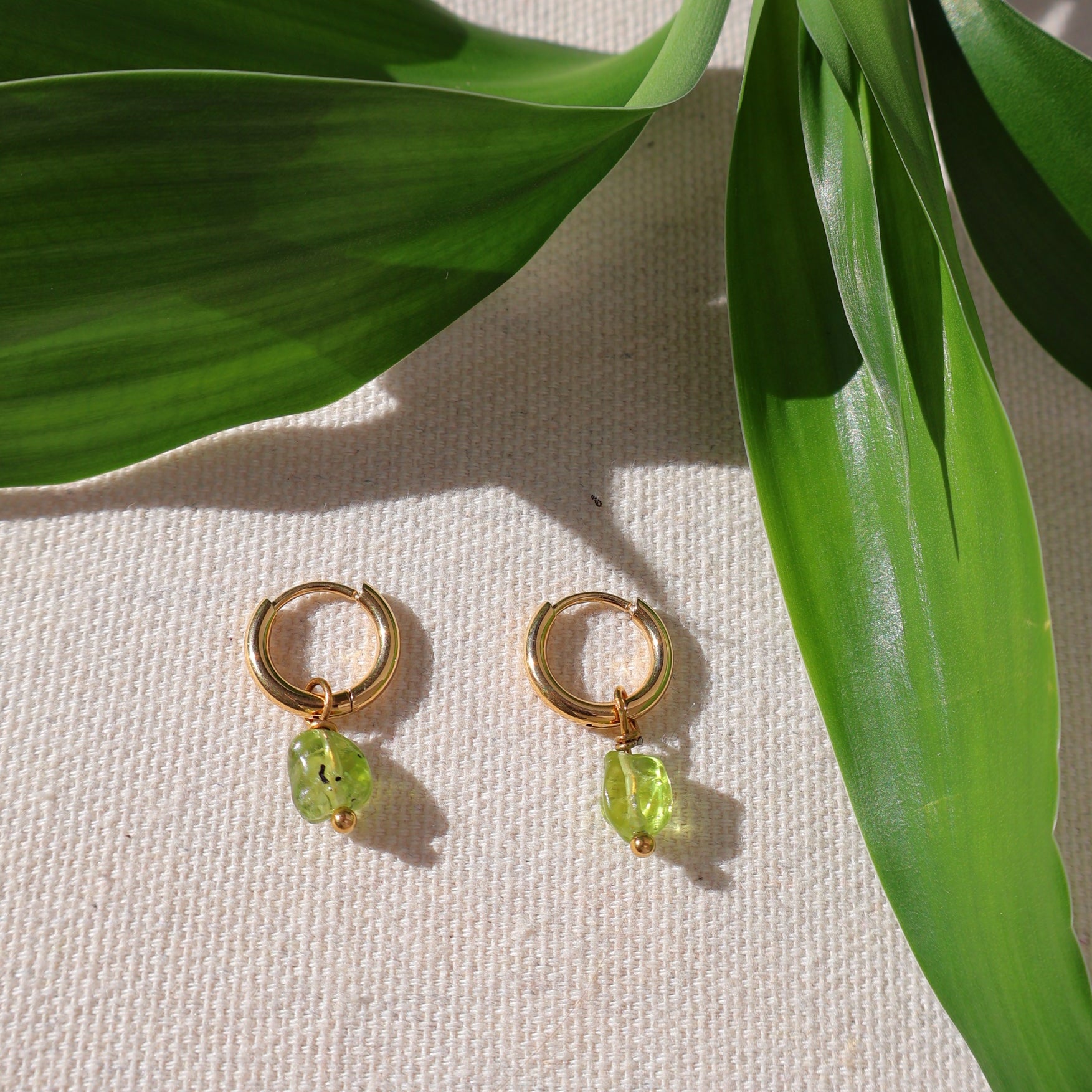 mini gold earrings with peridot